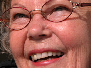 senior woman smiling wearing glasses